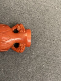 A Chinese carved red coral snuff bottle with a vase resting on a tortoise, Republic