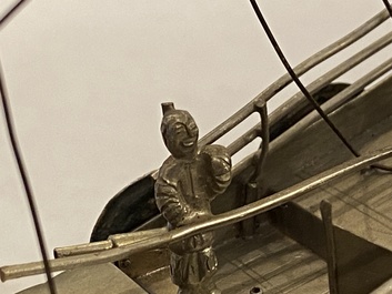 A large Chinese silver model of a junk on carved wooden stand, 19th C.