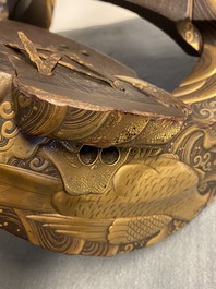 A Japanese gilt-lacquered 'kura' saddle with matching 'abumi' stirrups, Muromachi, 16th C.