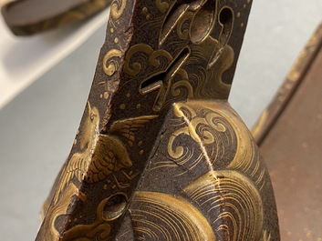 A Japanese gilt-lacquered 'kura' saddle with matching 'abumi' stirrups, Muromachi, 16th C.