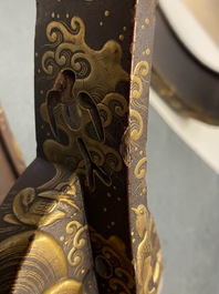 A Japanese gilt-lacquered 'kura' saddle with matching 'abumi' stirrups, Muromachi, 16th C.