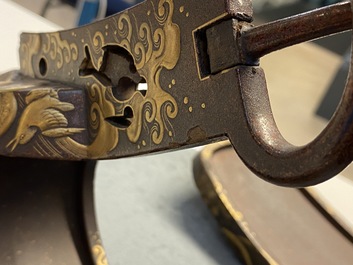 A Japanese gilt-lacquered 'kura' saddle with matching 'abumi' stirrups, Muromachi, 16th C.