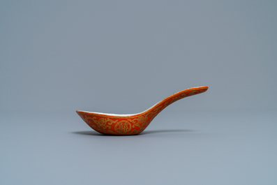 A Chinese iron red and gilt 'bats and Shou' spoon, Jiaqing mark and of the period