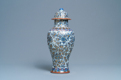 A Chinese blue and white clobbered vase and cover with floral design, Kangxi