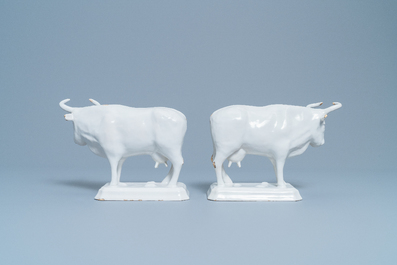 A pair of white Dutch Delftware cows on bases, 18th C.