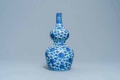 A Chinese blue and white 'lotus scroll' double gourd vase, Wanli