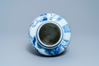 Een Chinese blauw-witte vaas met figuren in een interieur, Kangxi