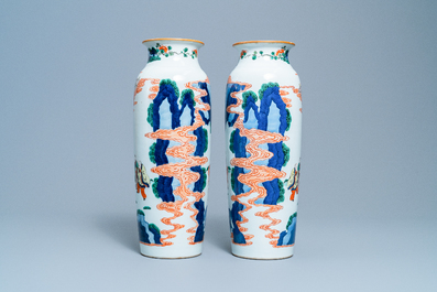 A pair of Chinese wucai rouleau vases with figures on horseback, 19th C.