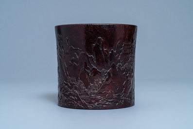 A Chinese carved zitan wood brush pot with a mountainous landscape, 17/18th C.