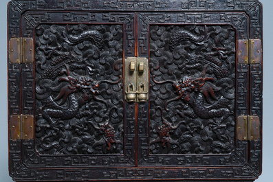 Un petit cabinet en bois sculpt&eacute; &agrave; d&eacute;cor de dragons, Chine, R&eacute;publique