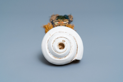 A TIbetan conch shell with embroidered silk ribbon, 19th C.