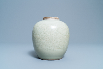 A Chinese monochrome celadon jar with underglaze lotus design, Kangxi