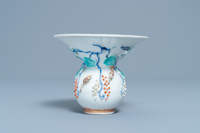 A Chinese relief-decorated 'squirrel and grapevine' spittoon, Yongzheng