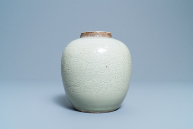 A Chinese monochrome celadon jar with underglaze lotus design, Kangxi