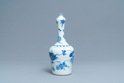 A Chinese blue and white bottle vase with floral design, Transitional period