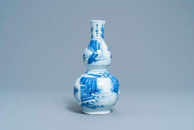 A Chinese blue and white double gourd vase with figures in a landscape, Transitional period