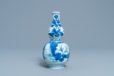 A Chinese blue and white double gourd vase with figures in a landscape, Transitional period