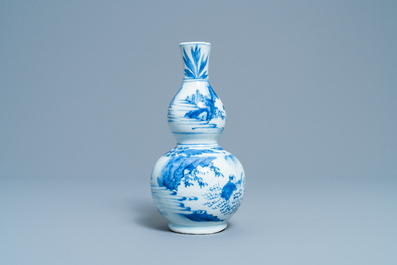 A Chinese blue and white double gourd vase with figures in a landscape, Transitional period