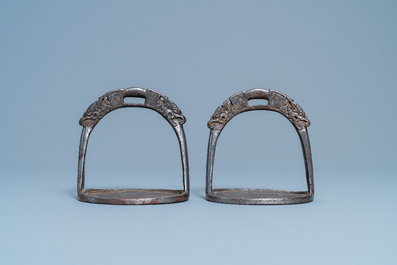 A pair of Tibetan iron stirrups with dragons, 17th C.