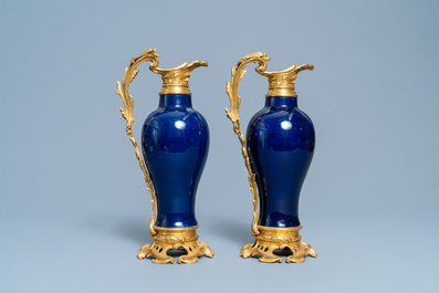 A pair of Chinese gilt bronze ewer-mounted monochrome blue vases, 18/19th C.