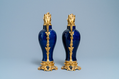 A pair of Chinese gilt bronze ewer-mounted monochrome blue vases, 18/19th C.