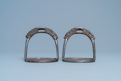 A pair of Tibetan iron stirrups with dragons, 17th C.