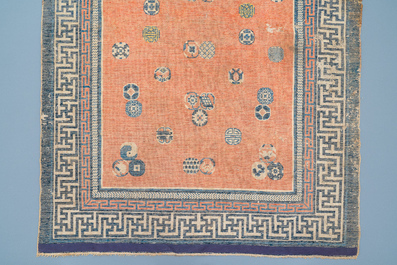 A rectangular Chinese hand-knotted wool carpet with brocade balls, 19th C.