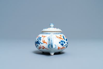 A rare Chinese blue, white, iron red and gilt tripod teapot and cover, Kangxi