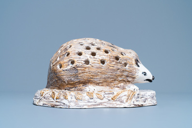 A polychrome faience flower holder shaped as a hedgehog, Northern France, 18/19th C.