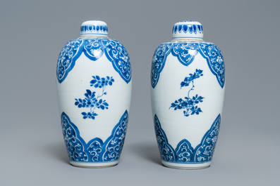 A pair of Chinese blue and white lidded jars with floral design, Kangxi