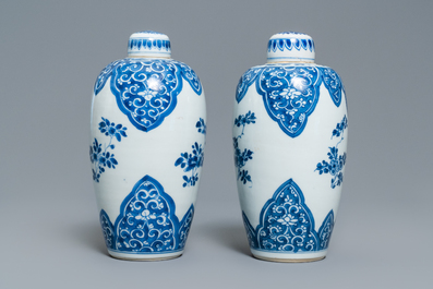 A pair of Chinese blue and white lidded jars with floral design, Kangxi