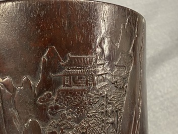 A Chinese carved zitan wood brush pot with a mountainous landscape, 17/18th C.