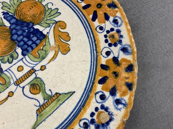 A polychrome Dutch maiolica dish with a fruit tazza, 1st half 17th C.