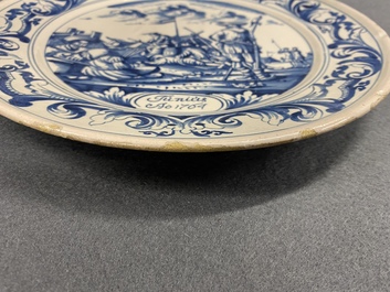 A Dutch Delftware blue and white dish with soldiers at camp, Makkum, dated 1764