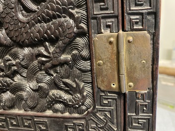 Un petit cabinet en bois sculpt&eacute; &agrave; d&eacute;cor de dragons, Chine, R&eacute;publique