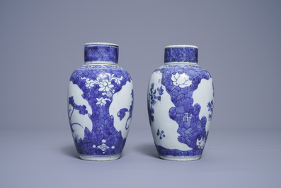 A pair of Chinese blue and white vases and covers with floral design, Hatcher cargo shipwreck, Transitional period