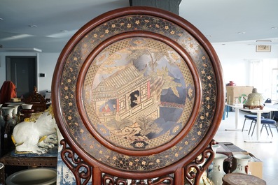 A massive Chinese carved wooden screen with a round famille verte plaque and polychrome lacquer, 19th C.