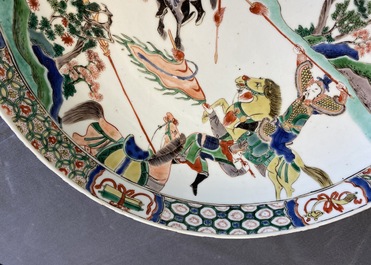 A Chinese famille verte dish with warriors on horseback, Kangxi