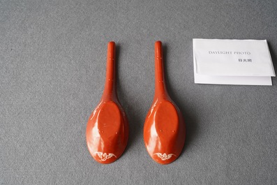 A pair of Chinese reverse-decorated iron red spoons, 19th C.