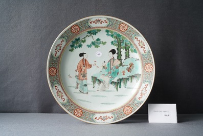 A large Chinese famille verte dish with ladies and boys in a garden, Kangxi