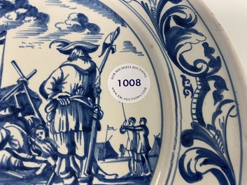 A Dutch Delftware blue and white dish with soldiers at camp, Makkum, dated 1764