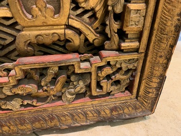 A Chinese carved and gilt wooden panel with red painted characters, 18/19th C.