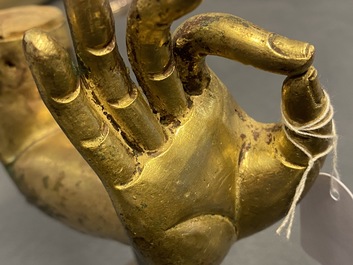 A Tibetan gilt bronze and copper alloy arm of Buddha, Ming