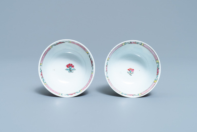 A pair of Chinese famille rose 'mountainous landscape' cups and saucers, Yongzheng