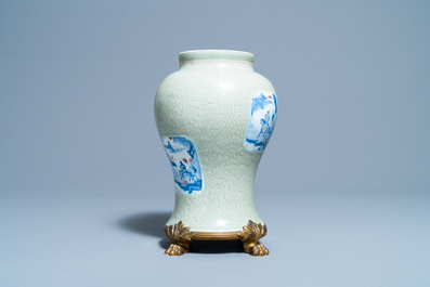 Un vase en porcelaine de Chine c&eacute;ladon monochrome &agrave; d&eacute;cor incis&eacute; et aux panneaux en bleu, blanc et rouge de cuivre, Kangxi