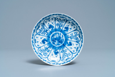 A Chinese blue and white French market covered cup and saucer, Kangxi