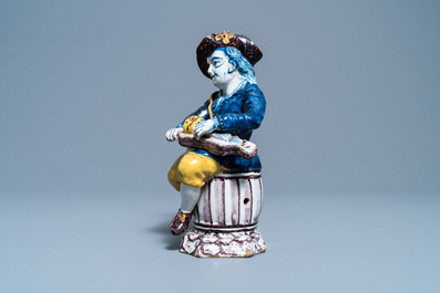 A polychrome Dutch Delft figure of a hurdy-gurdy player, 18th C.