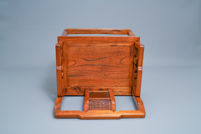 A Chinese wooden chair with inserted carved panels, 19th C.