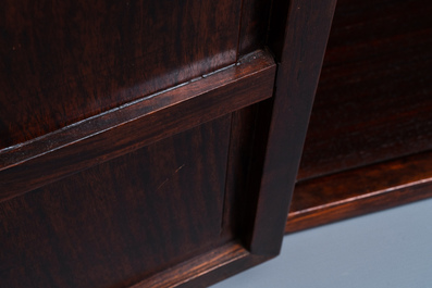 A Chinese wooden two-door cupboard with carved floral panels, 19th C.