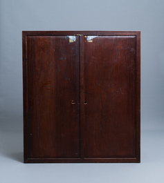 A Chinese wooden two-door cupboard with carved floral panels, 19th C.